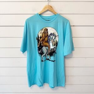 Fifth-Sun | Men’s Blue Bigfoot Riding Unicorn 100% Cotton T-Shirt Size 2XL